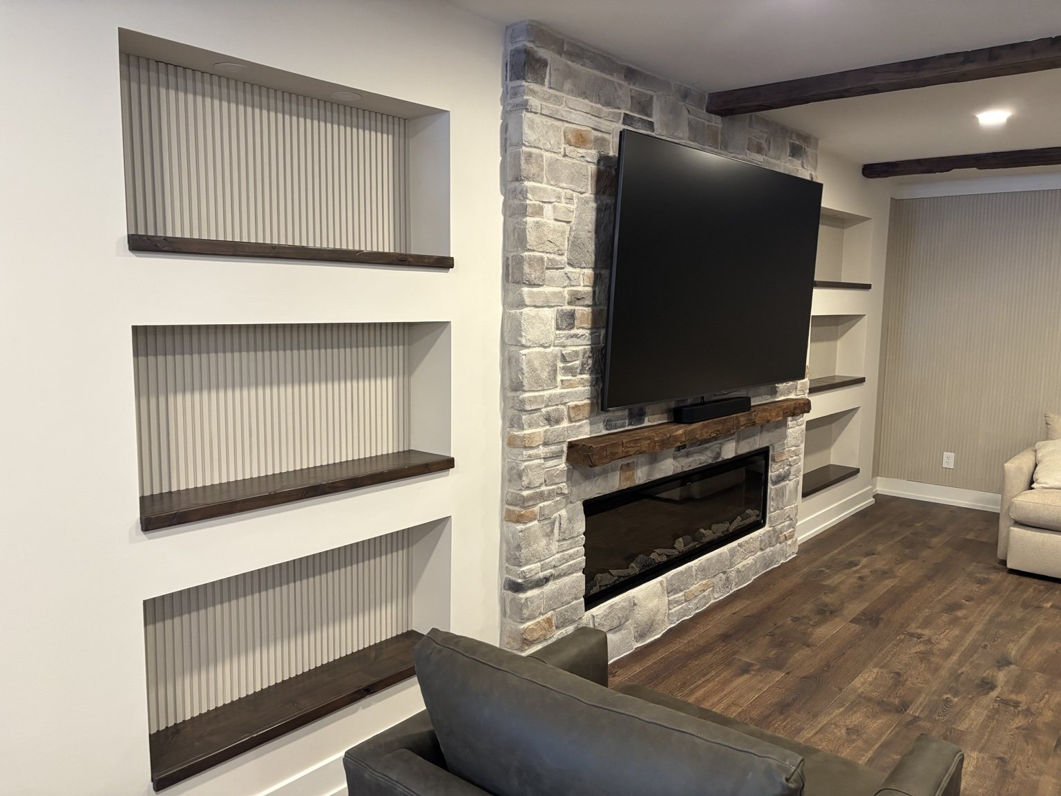 Fireplace with custom recessed shelving and stained wood shelves